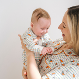 Baby wearing the ZIPSTER x Miffy Checkered Bloom bamboo babygrow