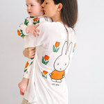 Woman wearing the Miffy white breastfeeding T-shirt with embroidered tulip and nursing zips