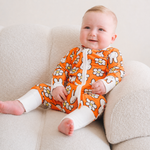 Baby wearing the ZIPSTER x Miffy Daisy Days bamboo babygrow
