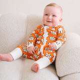 Baby wearing the ZIPSTER x Miffy Daisy Days bamboo babygrow